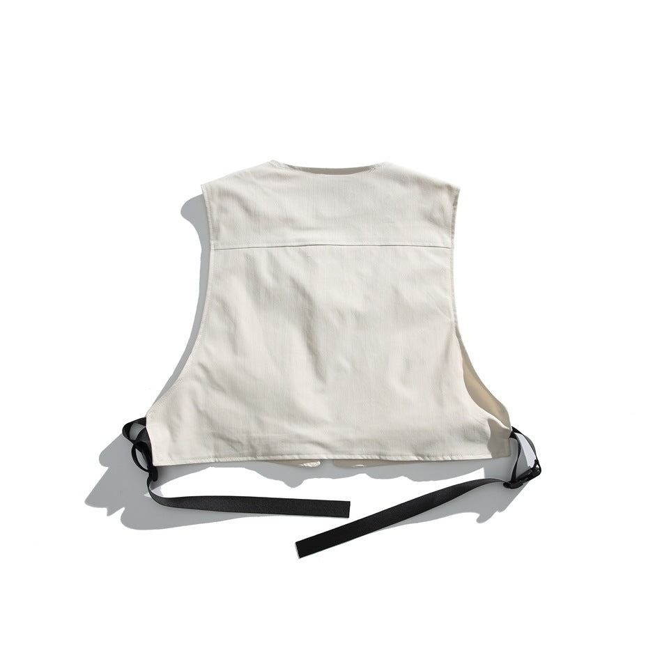 Back of an off-white sleeveless vest with black adjustable side straps, laid flat on a white background.