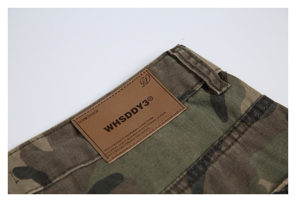 Close-up of the camouflage pants waistband and belt loop with a brown WHSDDY label.