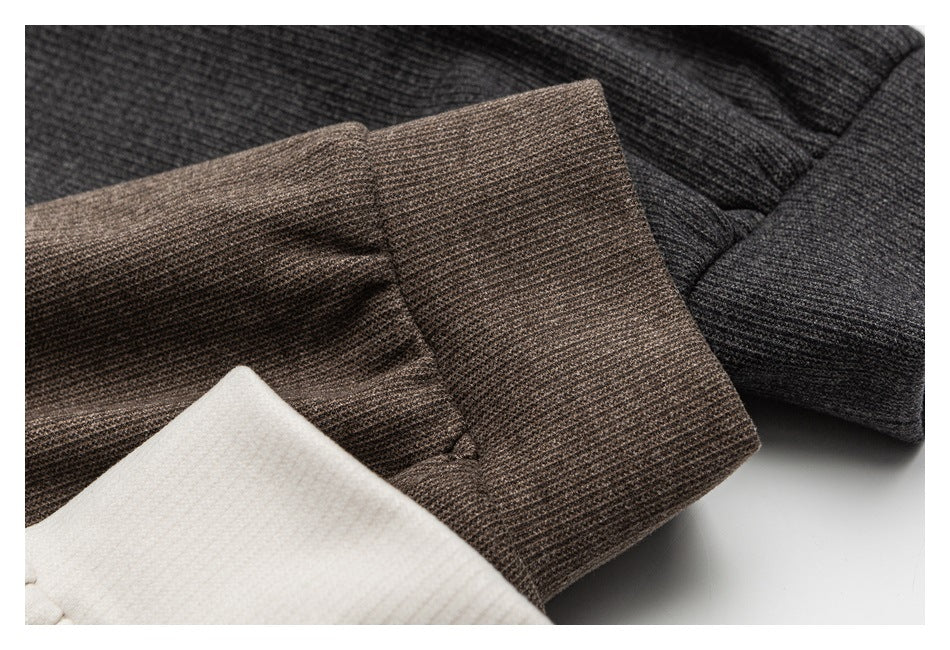 Close-up of ribbed jacket cuffs in brown, charcoal gray, and cream.