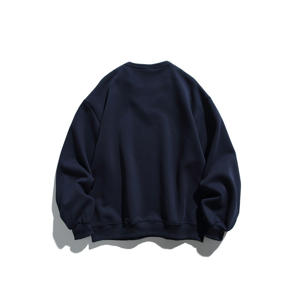 Back view of a plain dark navy crewneck sweatshirt with long sleeves and ribbed cuffs and hem, on white.