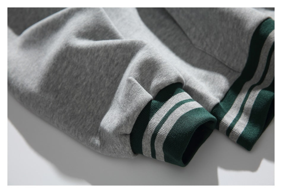 Close-up of the gray sleeves and green cuffs with two gray stripes.