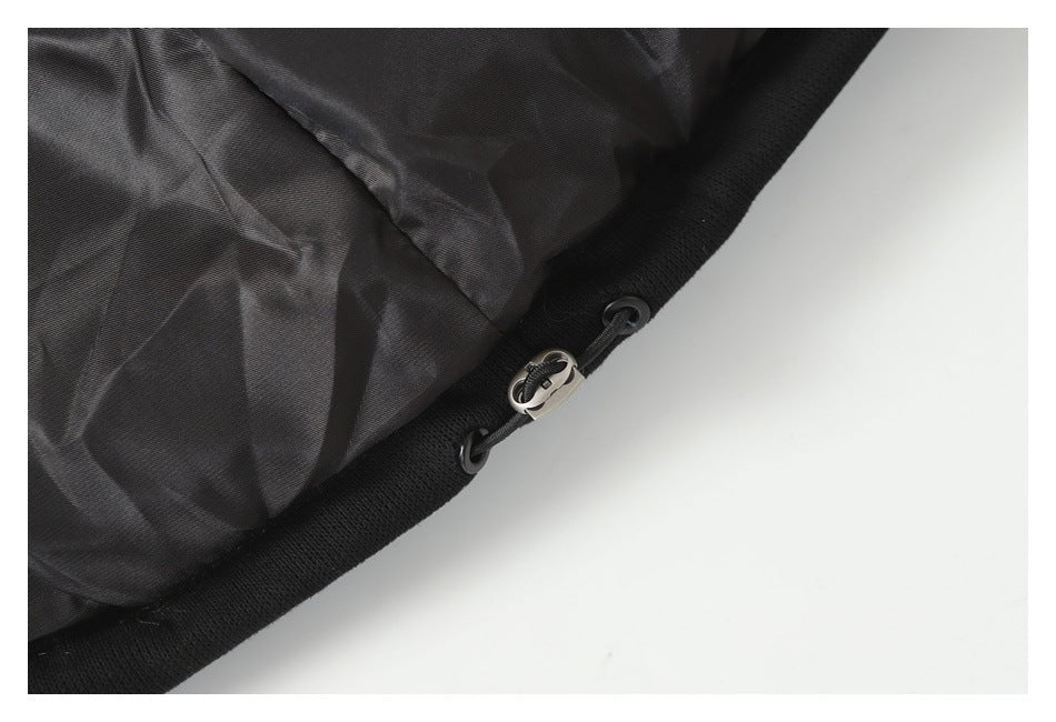 Close-up of black garment lining and a drawcord with a metal toggle.