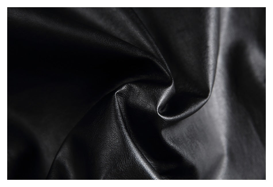 Macro view of the black jacket's smooth, folded surface.