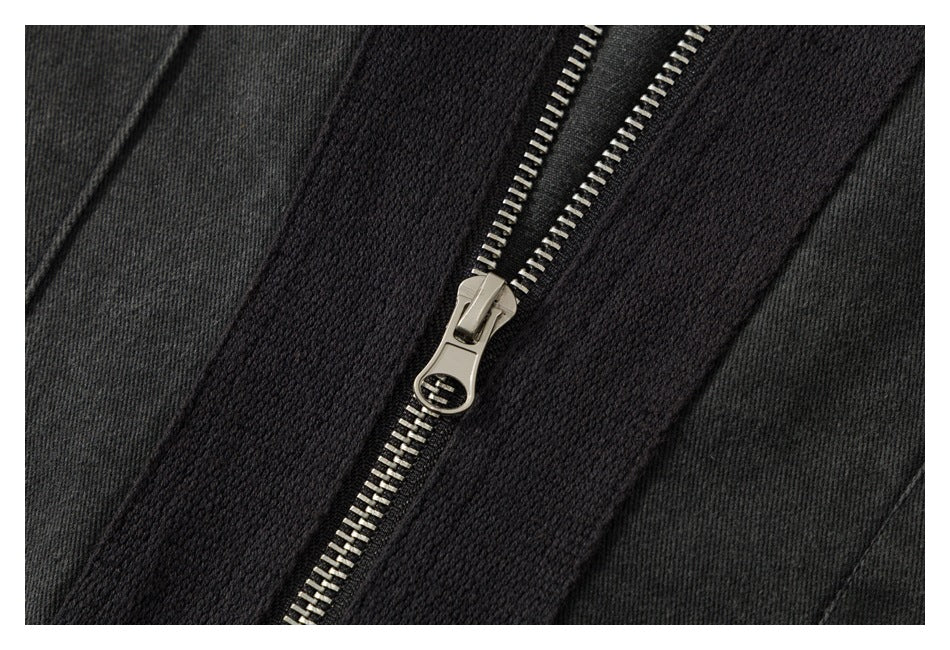 Extreme close-up of a silver metal zipper on a charcoal garment.