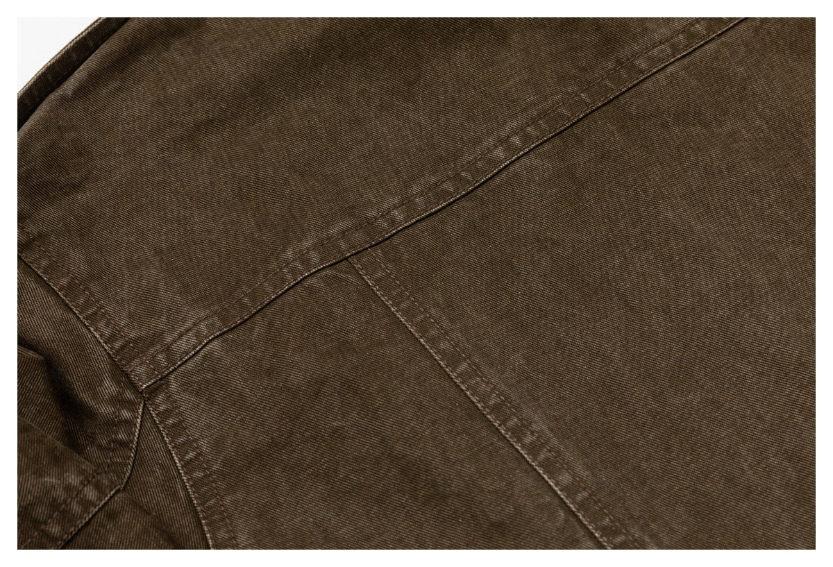 Close-up of brown garment panels showing stitched seams and a textured surface.