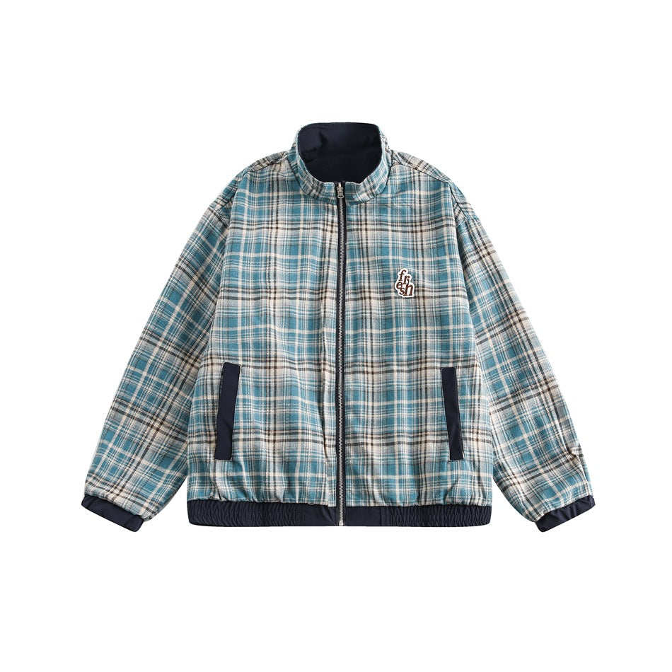 Reverse side of the jacket in teal and cream plaid with front zipper, navy pocket trim, navy cuffs and hem, and a small patch