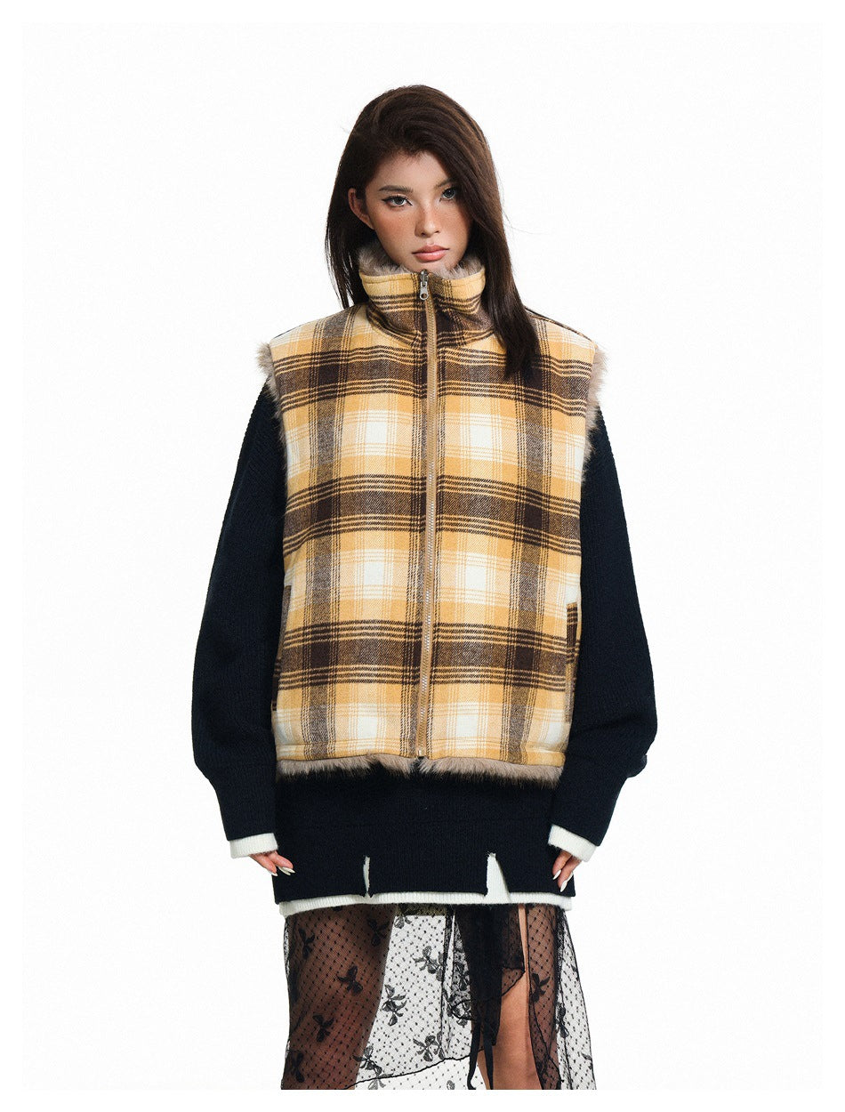 Model wearing a yellow, cream and brown plaid zip-front vest over a dark sweater.