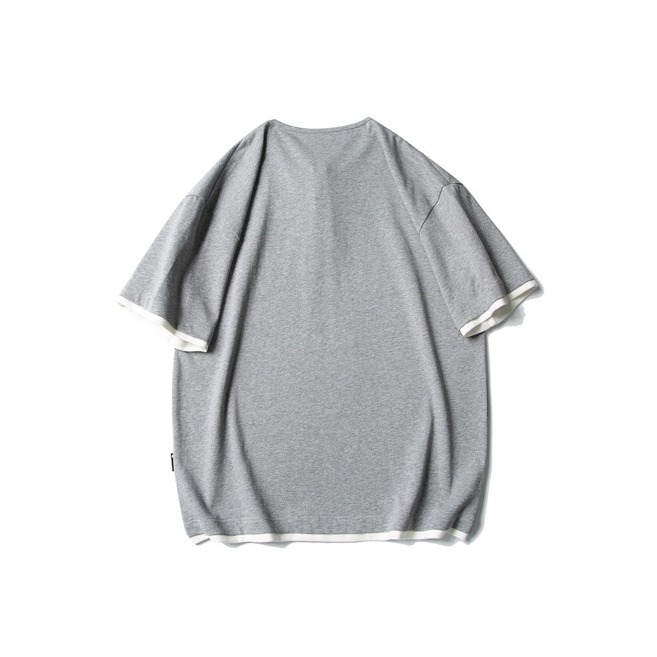 Back view of an oversized heather gray short-sleeve shirt with white trim at the cuffs and hem.