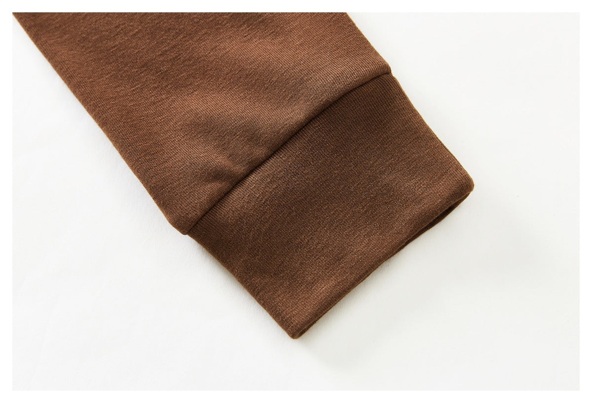 Close-up of the brown top's long sleeve and wide cuff.