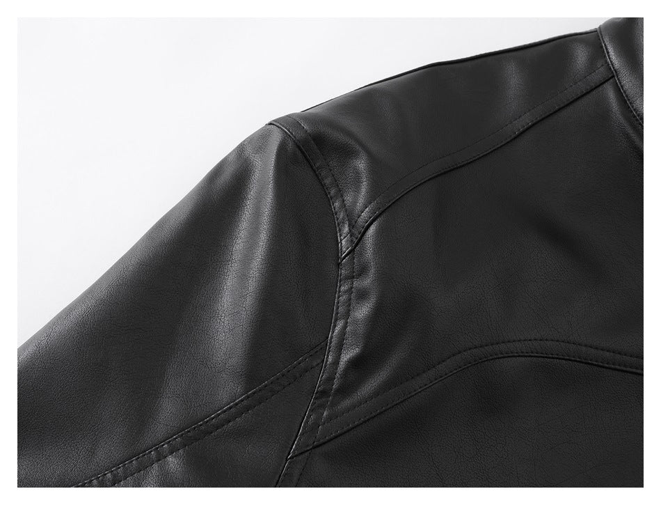 Close-up of a black jacket shoulder with curved stitched panel seams and a pebbled surface.