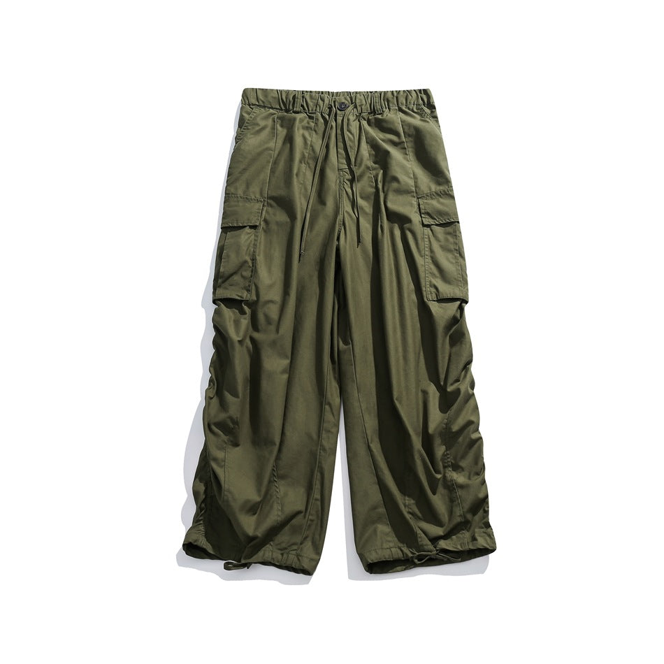 Army green wide-leg cargo pants flat lay with elastic waist, drawstring, flap pockets and drawstring hems