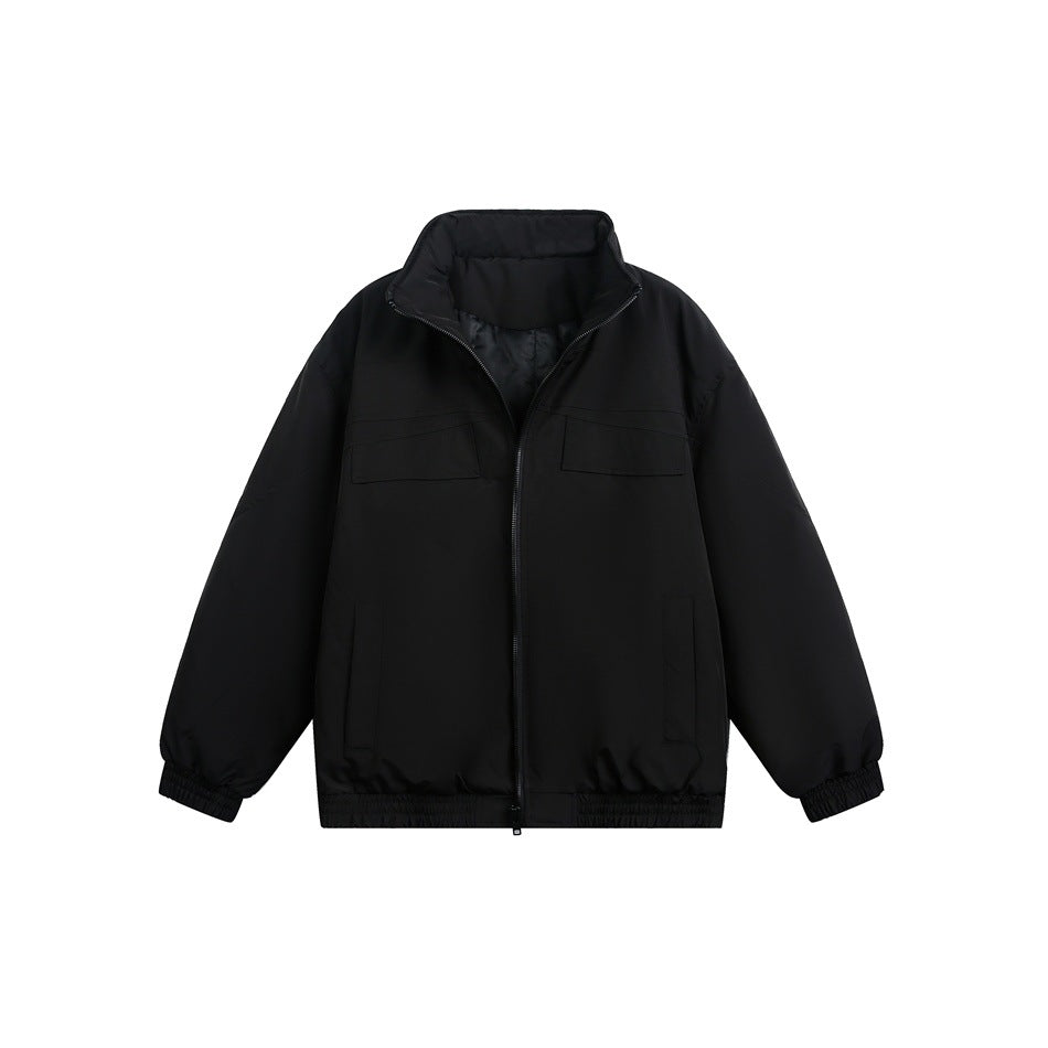 Front view of a black zip-front jacket with a high collar, chest flap pockets, and elasticated cuffs and hem.
