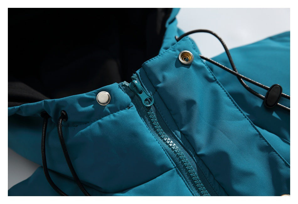 Teal jacket close-up showing a zipper, snap fasteners, and black drawcord with toggle.