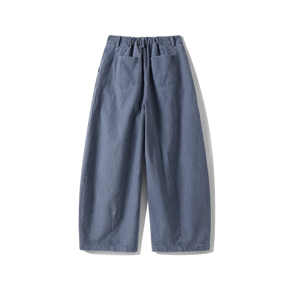 Back view of gray-blue wide-leg pants with two patch pockets, partial elastic waistband and hem vents