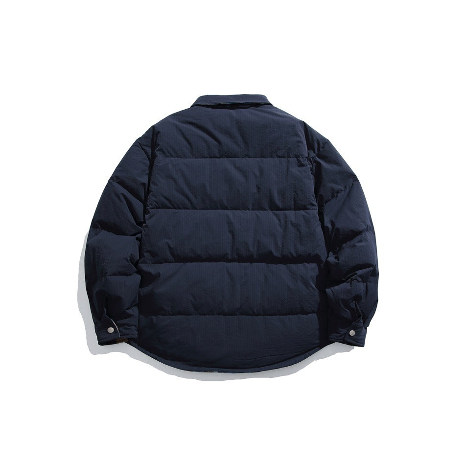 Back view of a dark navy quilted jacket with horizontal padded panels and snap cuffs.