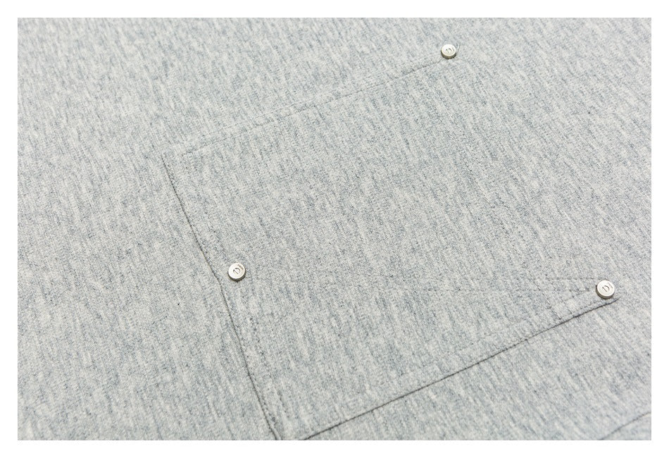 Close-up of a heather-gray sweatshirt pocket with three small round buttons.