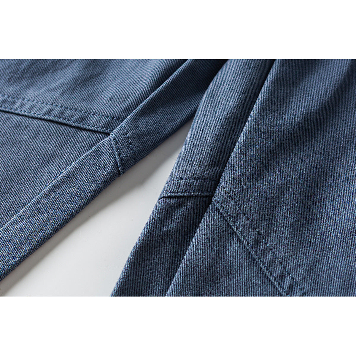 Close-up of blue fabric panels with visible seam stitching.