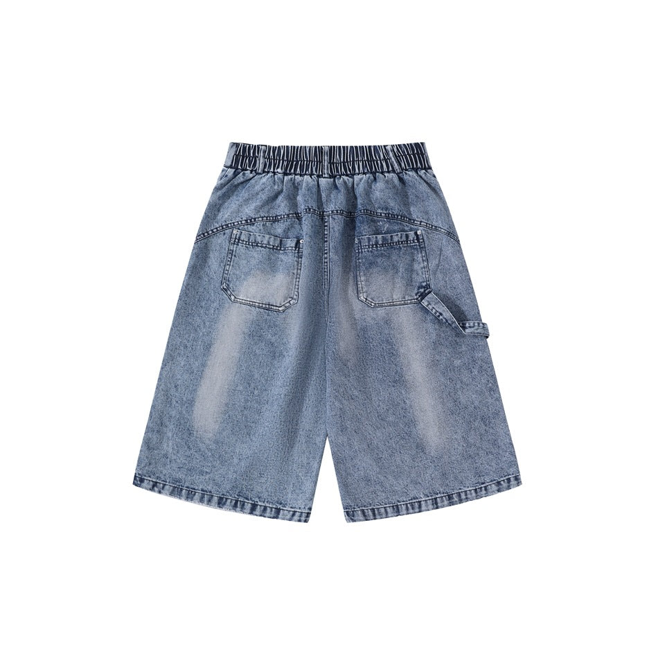 Back view of blue washed denim shorts with elastic waistband, two patch pockets and side utility loop