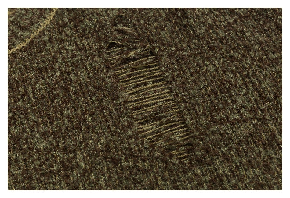 Close-up of a brown and olive fuzzy knit with a narrow diagonal stitched detail.