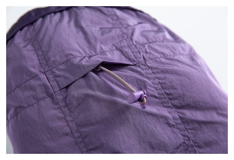 Close-up of a purple hood with a multicolored drawcord and purple toggle.