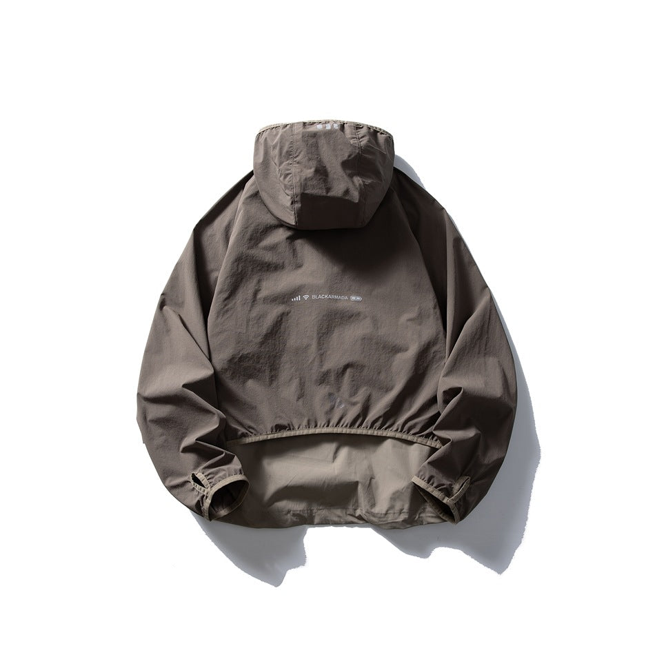 Back view of a taupe-gray hooded jacket with a color-blocked lower panel and small center-back print.