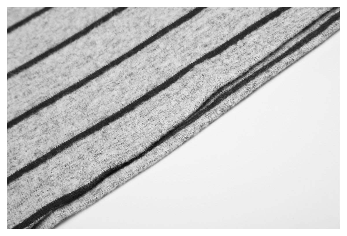 Close-up of the striped shirt's folded hem and stitched edge.