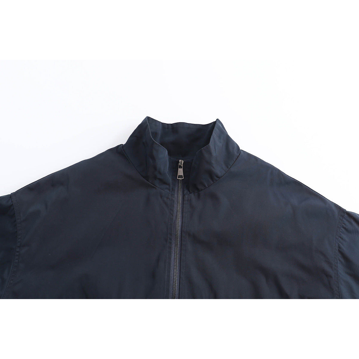 Close-up of a dark navy jacket's stand collar and central zipper.