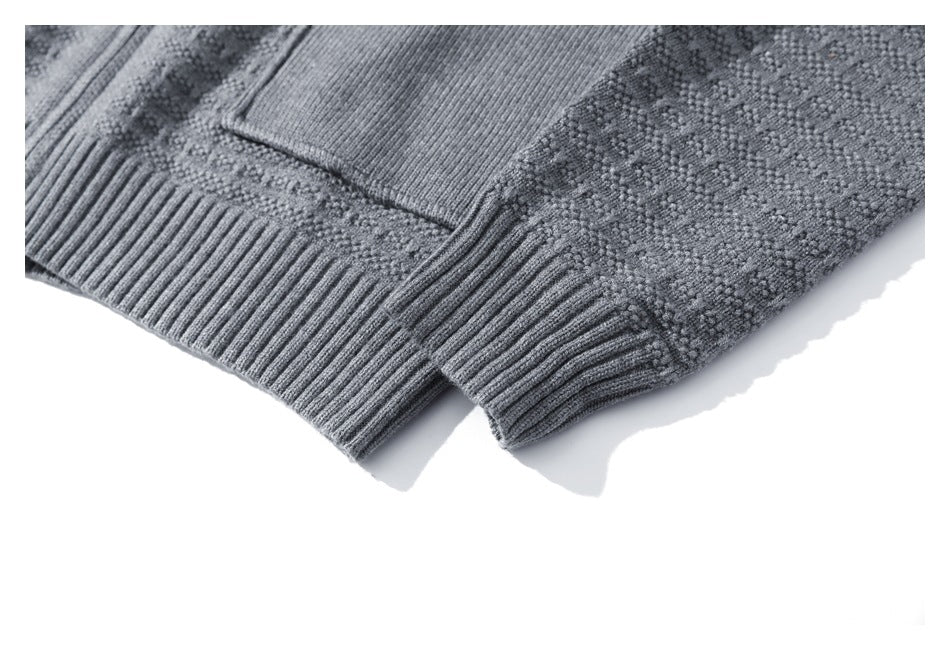 Close-up of a gray textured cardigan's ribbed hem and sleeve cuff.