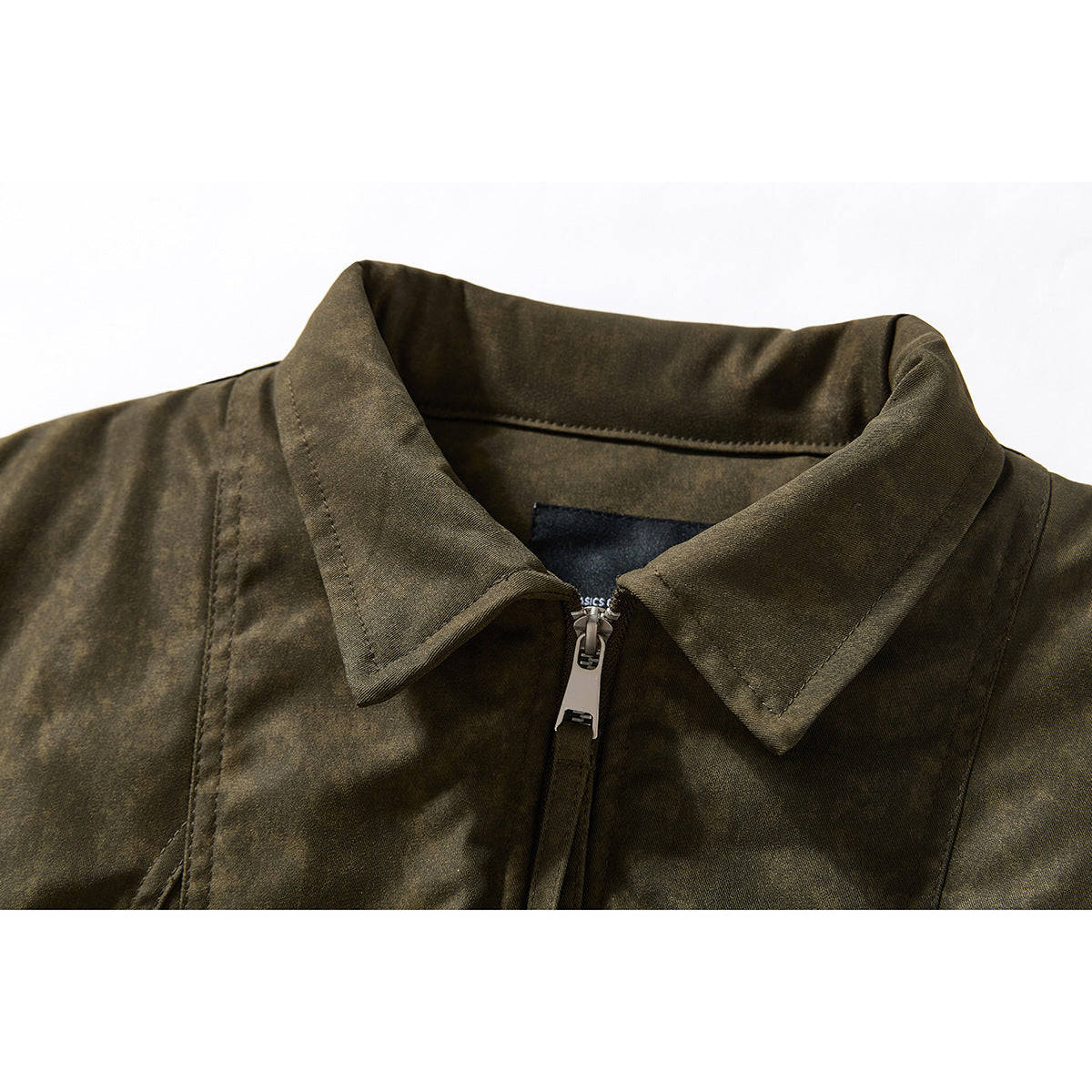Close-up of an olive-brown jacket collar and silver front zipper.