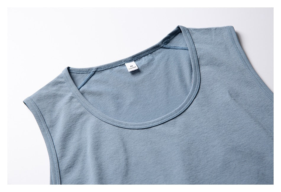 Close-up of the blue-gray top's rounded neckline, shoulder seams, and small inner neck label.
