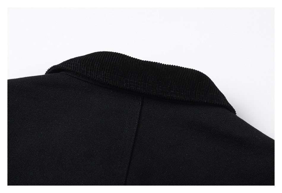 Close-up of a ribbed black collar and center back seam.