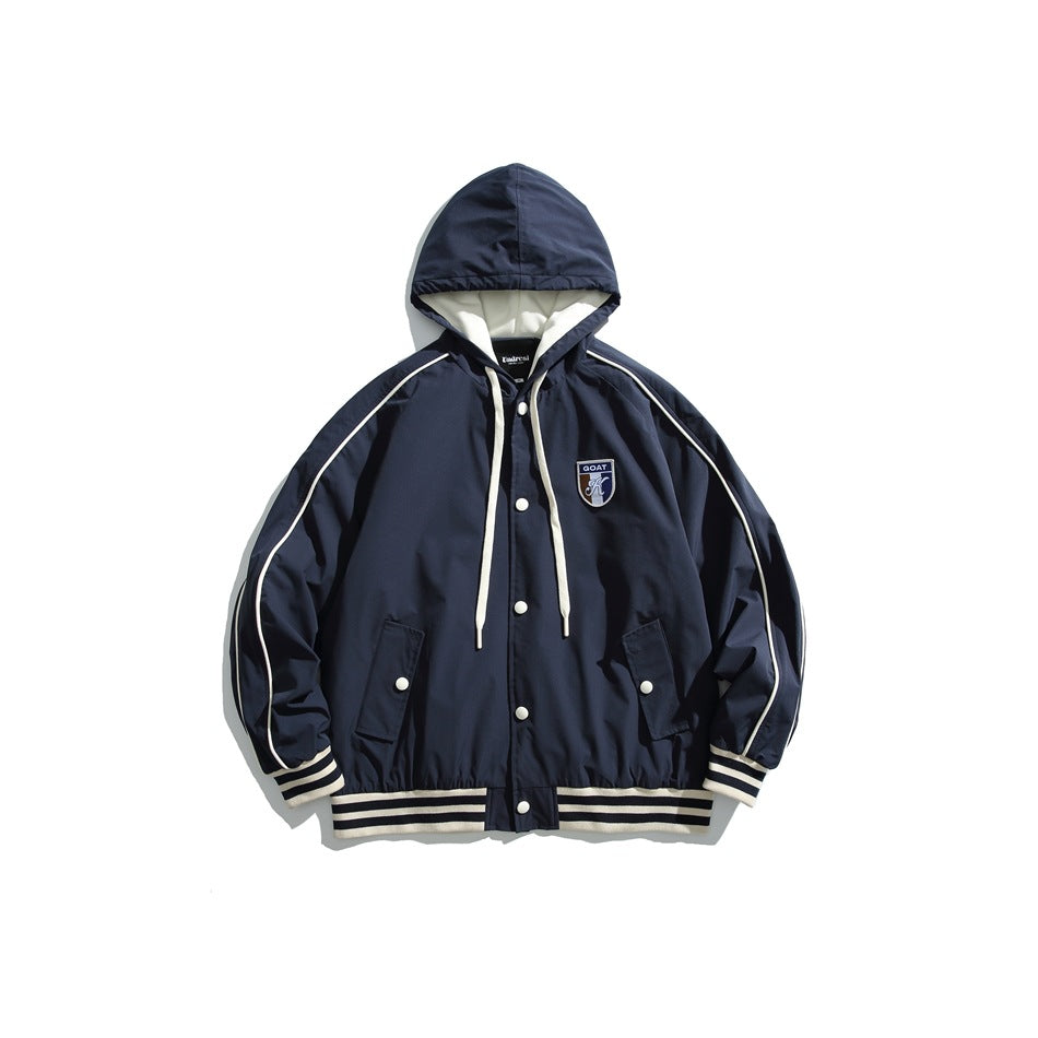 Navy hooded snap-front jacket with cream piping, striped trim and chest shield patch, flat lay