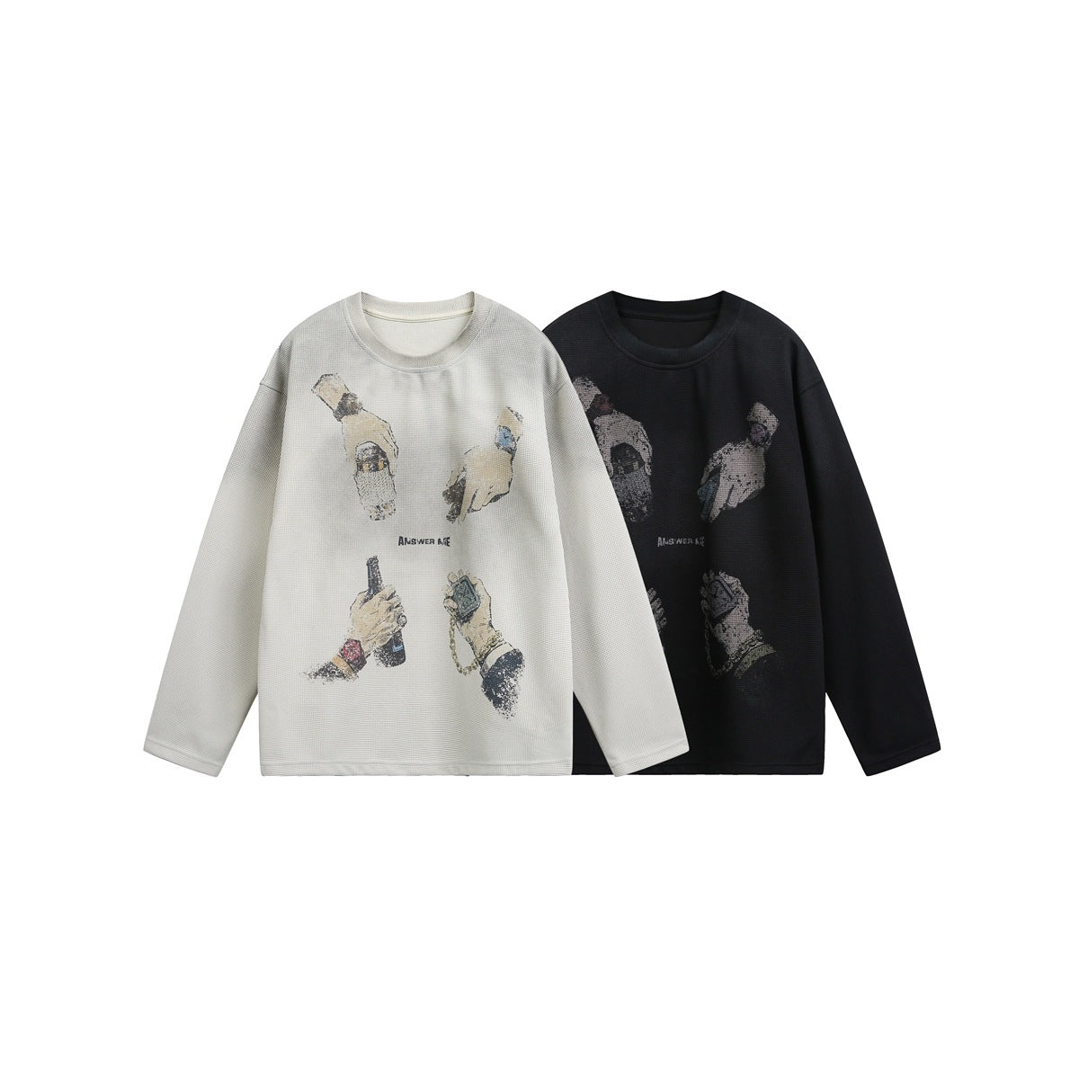 Cream and black long-sleeve crewneck tops shown from the front, each with illustrated graphics across the chest.
