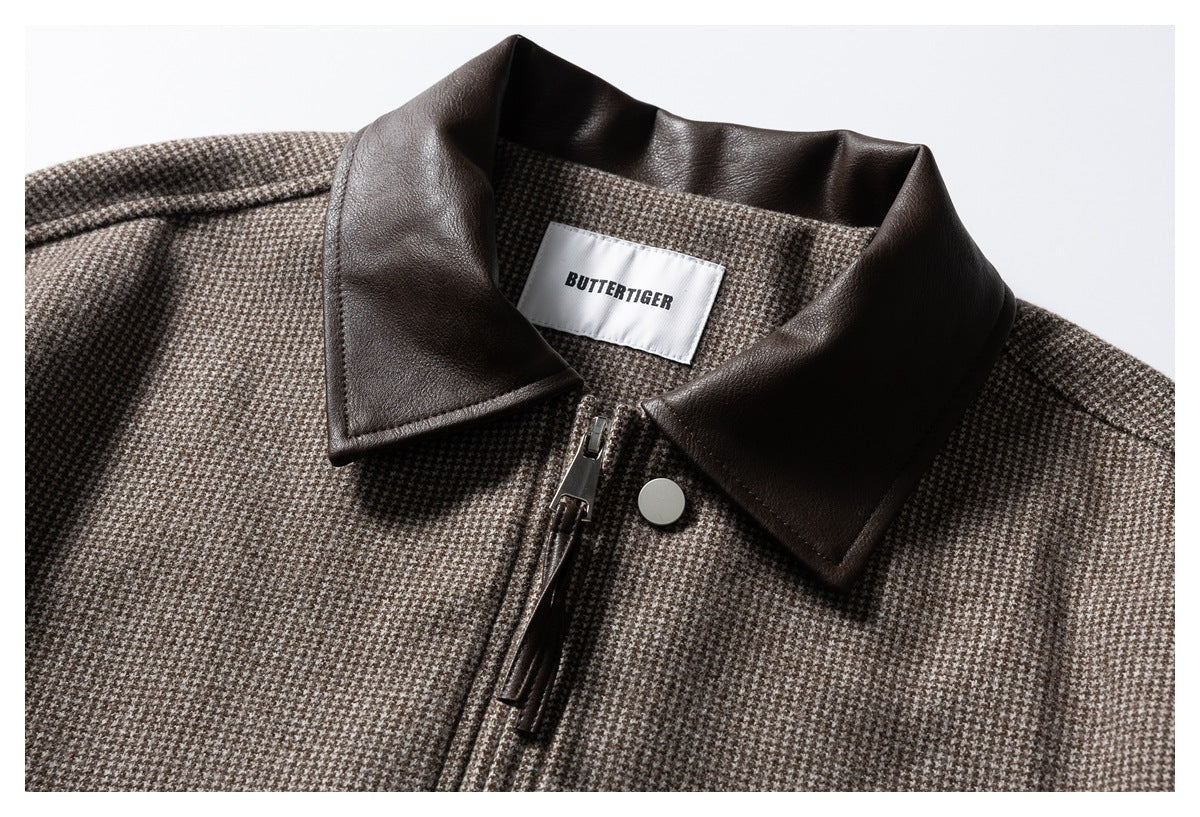 Close-up of a brown-and-cream houndstooth jacket with a dark brown collar, front zipper, snap, and sewn-in label.