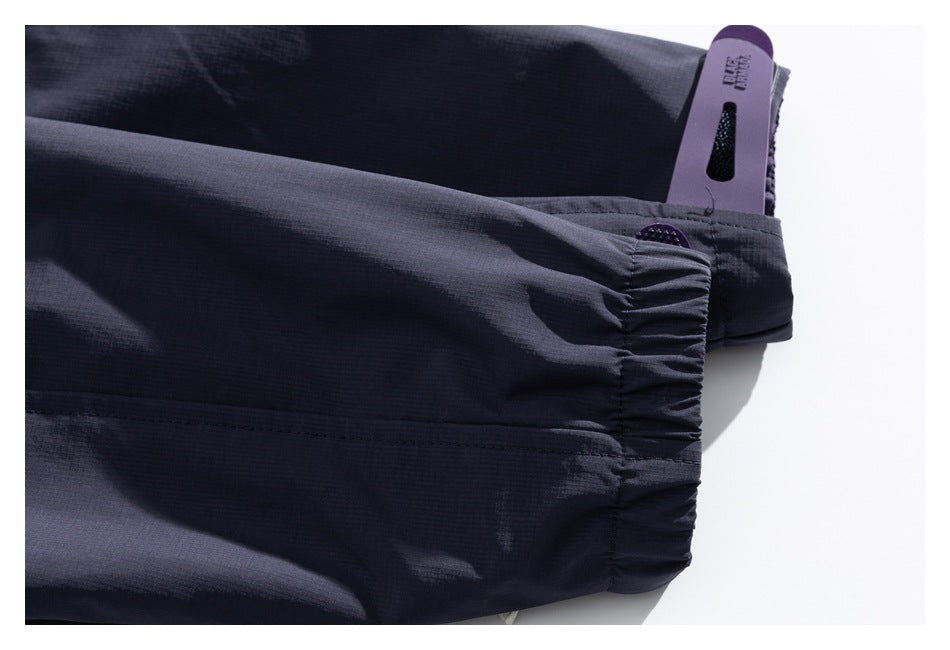 Close-up of the jacket's gathered elastic cuff and attached purple hangtag.