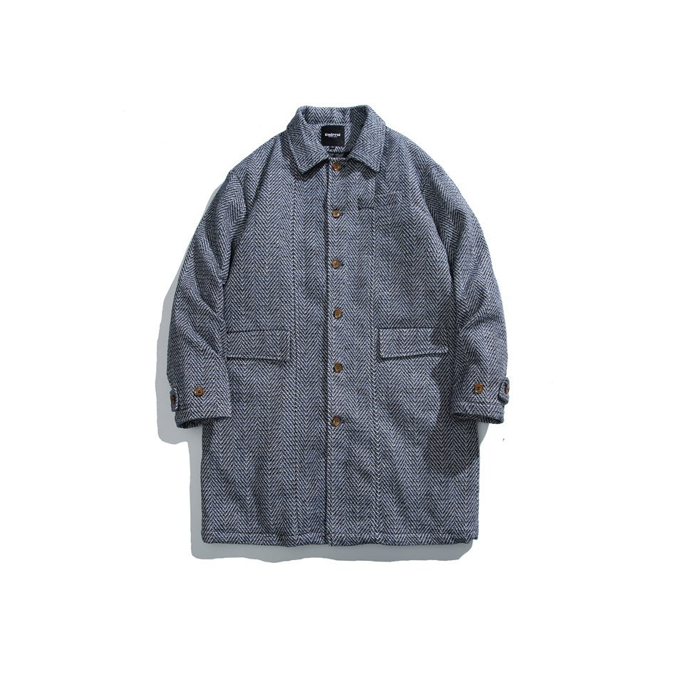 Blue herringbone-textured mid-length button-front coat with point collar and flap pockets, flat lay