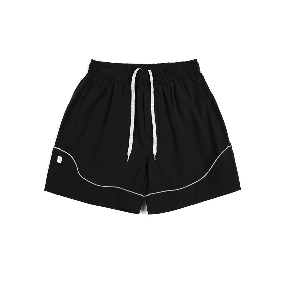 Black athletic shorts with a white drawstring, elastic waistband, and curved white piping.