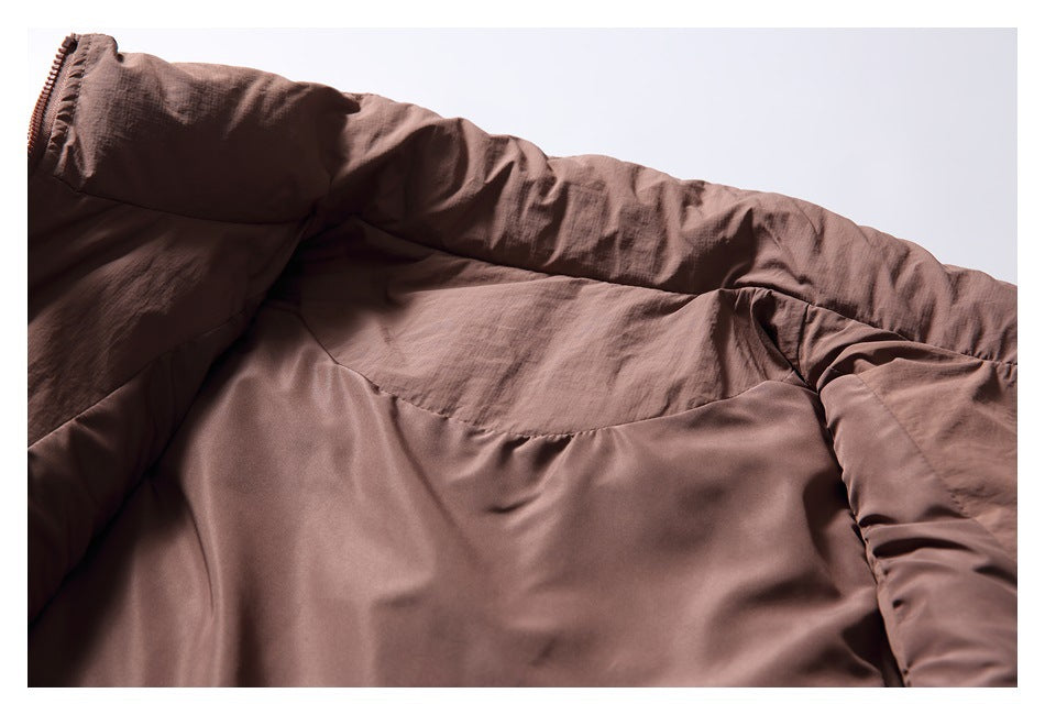 Close-up of the brown jacket's interior lining and collar, with a zipper edge visible at left.
