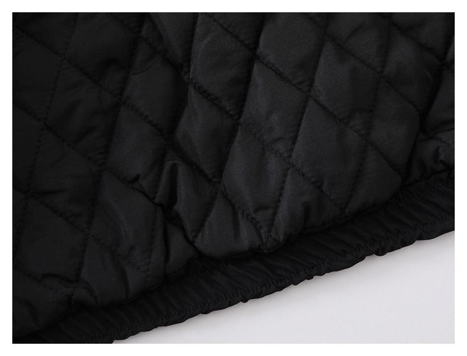 Close-up of black diamond-quilted fabric and a gathered elastic edge.