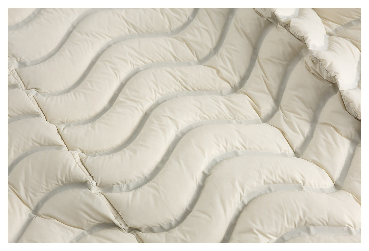 Close-up of ivory padded jacket fabric with curved gray piping and quilted channels.