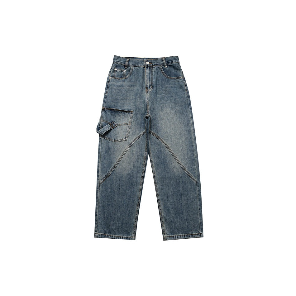 Washed blue wide-leg jeans flat lay, front view, with a large left leg patch pocket and diagonal seams