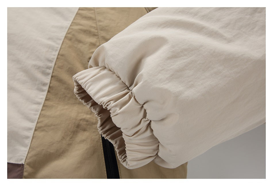 Close-up of a cream jacket sleeve with a gathered elastic cuff.