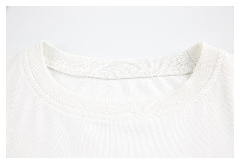 Close-up of the white T-shirt’s crew neckline and collar stitching.
