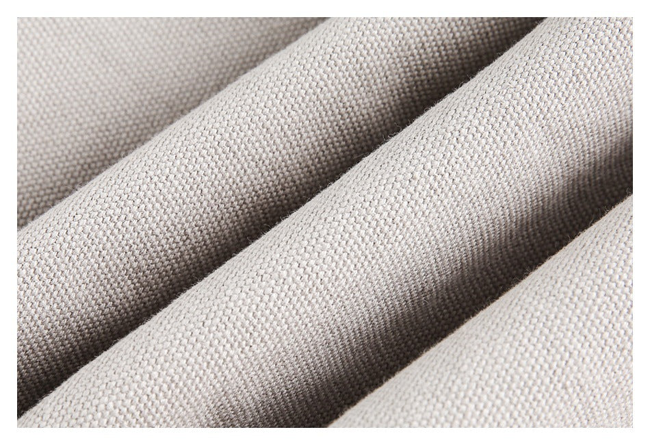 Close-up of light gray-beige woven fabric with a small, regular texture and soft folds.