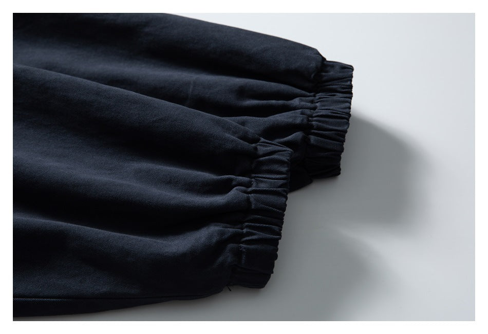 Close-up of gathered elastic cuffs on a dark navy jacket sleeve.