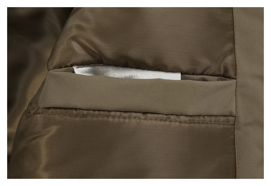 Close-up of a horizontal welt pocket on a taupe-brown jacket.