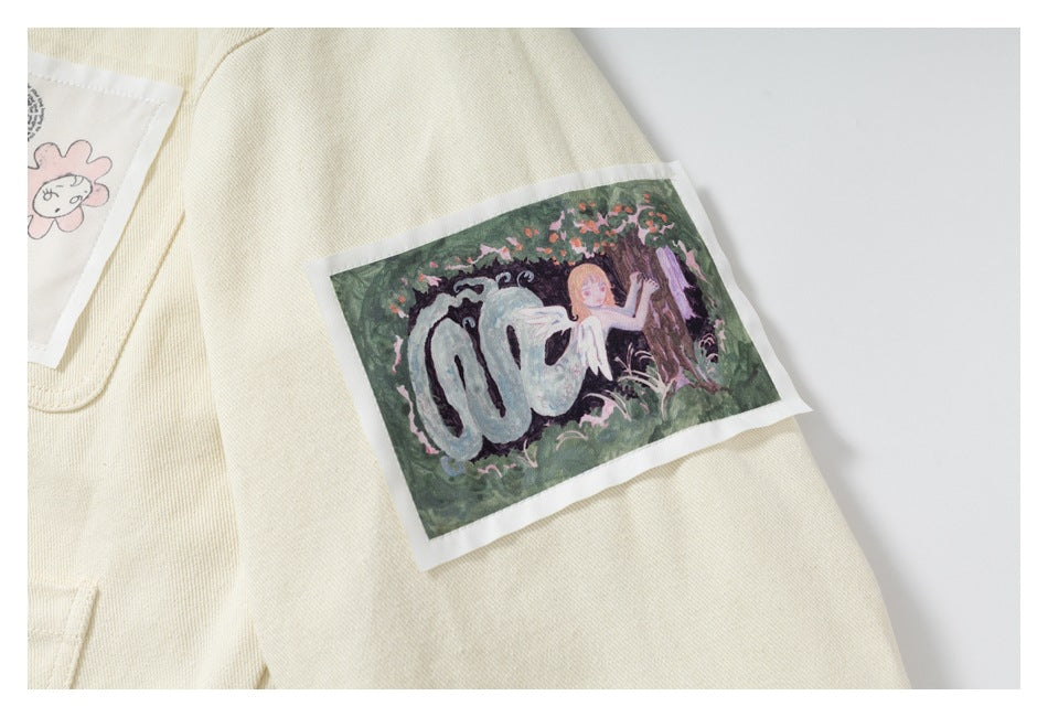 Cream jacket sleeve detail with a rectangular illustrated patch showing a figure in a garden.