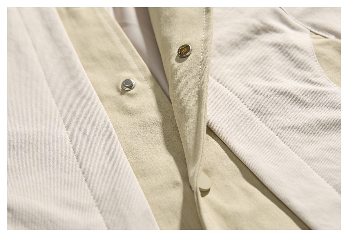 Close-up of the cream jacket's beige front placket with metal snap fasteners.