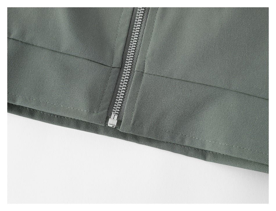 Close-up of the jacket's lower front, showing the metal zipper and stitched hem.