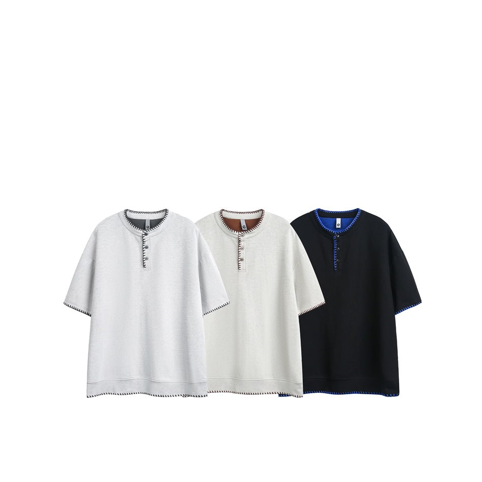 Three short-sleeve henleys shown together in light gray, off-white and black, each with contrast stitching.